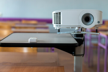 Modern video projector at business conference or lecture in office. Projector on wooden table...