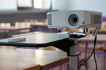 Modern video projector at business conference or lecture in office. Projector on wooden table...