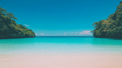 Tranquil turquoise water laps a white sand beach, framed by lush green cliffs.