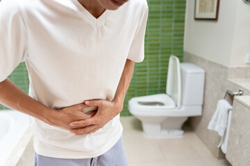 Constipation and diarrhea in bathroom. Hurt man touch belly  stomach ache painful. colon...