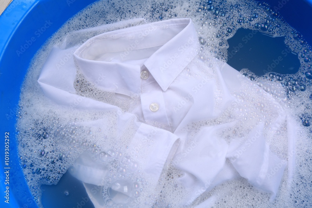 Canvas Prints White shirt in suds, closeup. Hand washing laundry