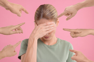 People pointing at embarrassed woman on pink background