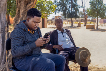 african village, social worker volunteer NGO making population census, old man sitting on his chair...