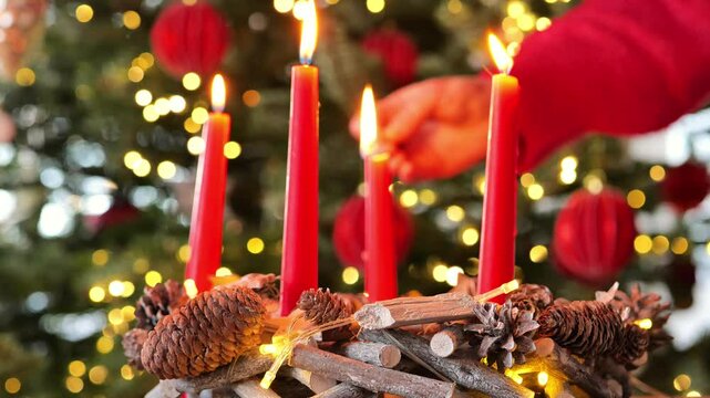 Fourth Advent. Woman lights candle of Advent wreath on Christmas beautiful tree background.Fourth week before Christmas. Christmas traditions and customs. 4k footage
