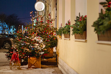Christmas street decor. Festive trees with Christmas red balls.