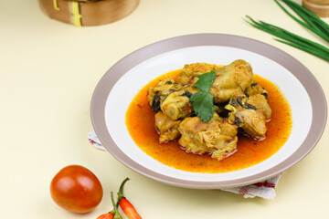Ayam rica-rica, Indonesian traditional spicy chicken with spicy sauce and basil leaves. Isolated background.