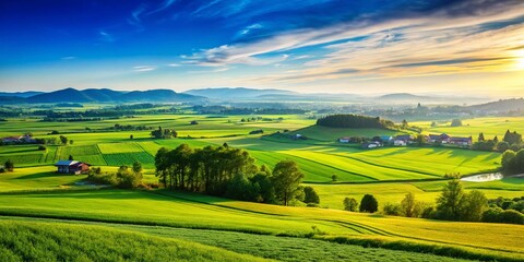 Fototapeta premium Serene Landscape of Outskirts with Lush Green Fields and Distant Hills Under a Clear Blue Sky