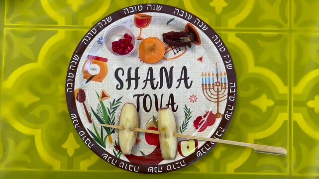 Flat lay view of Rosh Hashanah Seder Plate on Jewish day of judgement preceding Yom Kippur (day of atonement), one of several Jewish New Years