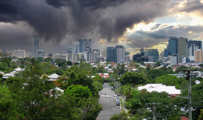 Heavy tropical storm clouds and rain over the city of Brisbane, Queensland, Australia with beams of...