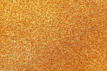 Shiny golden glitter as background, top view