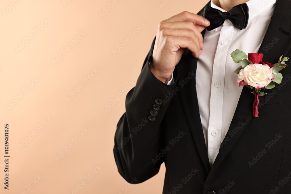 Canvas Prints Groom in suit with stylish boutonniere on beige background, closeup. Space for text