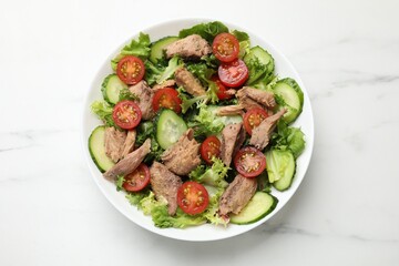 Delicious fresh tuna salad on white table, top view