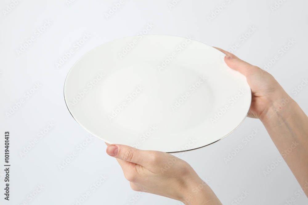 Poster Woman with empty ceramic plate on white background, closeup