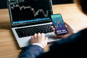 Investors analyze the data stock market index via smartphone screen to trade the stock chart for planning investments take profit, trade stock exchange market and cryptocurrency data, financial.