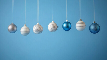 Decorative blue and silver ornaments hanging against a simple background on Christmas Day