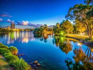 Fototapeta premium Tranquil Lake Orr at Gold Coast Surrounded by Lush Greenery and Clear Blue Skies in Queensland