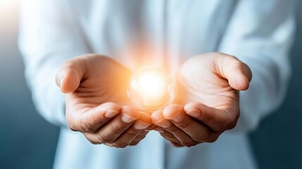 Hands holding a glowing orb, symbolizing potential and mindfulness.
