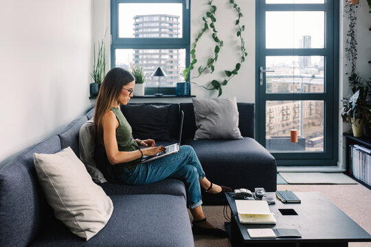 Businesswoman using a laptop computer to work remotely from London
