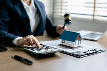 Female Real Estate Broker presenting and advised to 
model home and building project detail in the...