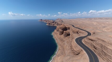 Winding Road Through Arid Desert Landscape With Ocean View