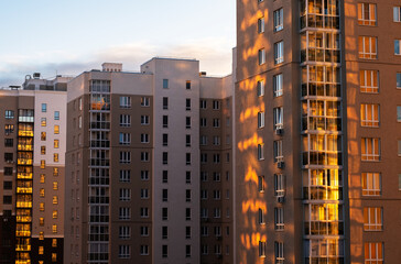 Fototapeta premium High rise community housing on sunset with sun reflection.