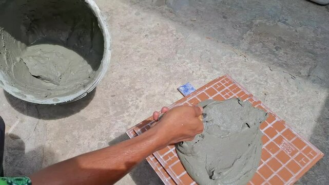 a construction worker is mixing cement