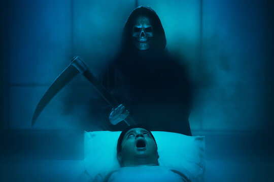 Silhouette of grim reaper with scythe and smoke mist fog kill man in bed, Halloween theme
