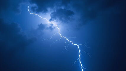 Thunder and lightning on a background with a blue sky Light thunderstorm with strikes in the dark Clouds with a powerful electric charge
