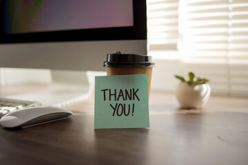 Fototapeta premium Words Thank You Written on Sticky Note at Office