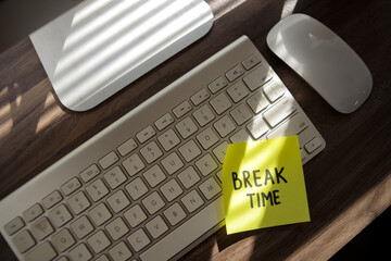High angle of Break time text on a yellow sticky note stuck on a computer screen. Business concept.
