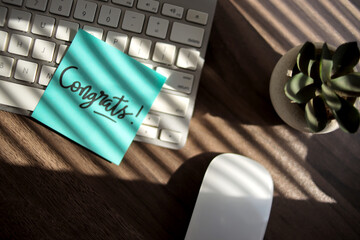 Sticky Notes with Congrats Text on Keyboard
