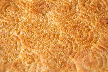 close up of baking naan bread with sesame seeds background.