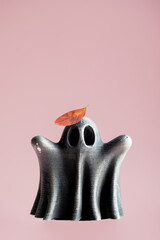 Ghost figure topped with autumn colored leaf. Artistry and seasonal themes.