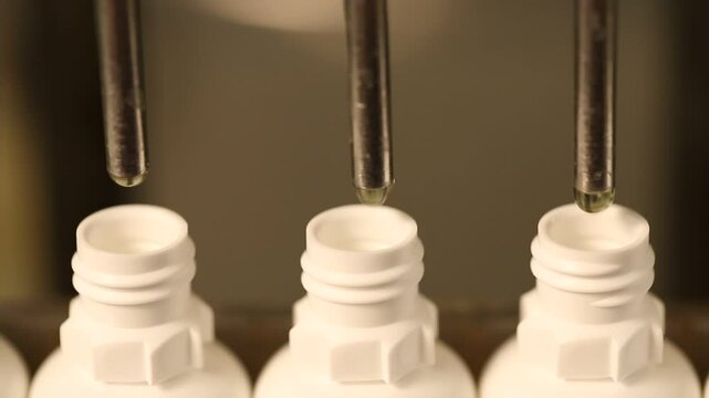 eye drop manufacturing. Ophthalmic drops solution, eye ear drop making process in factory. eye drop medicine in plastic bottles on conveyor belt. production of medical drops in a pharmaceutical line.