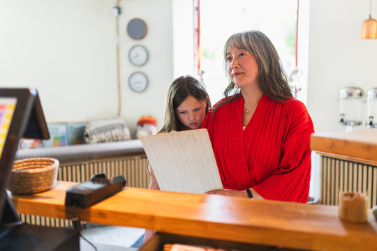 Mother and Daughter Ordering at Cash Register in Korean Restaurant