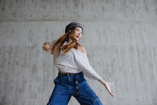 Young Woman Dancing in Urban Setting