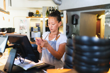 Small Business Owner Working at Cash Register in Korean Restaurant