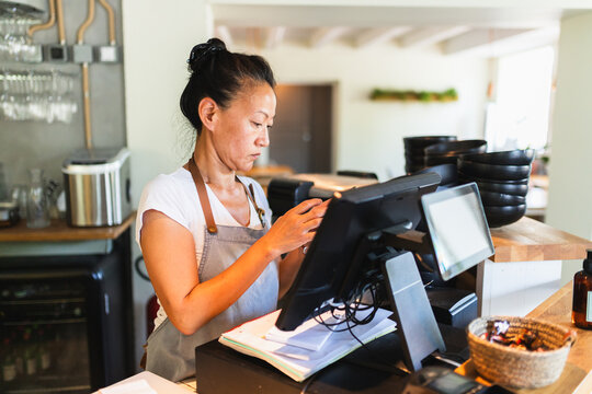 Small Business Owner Working at Cash Register in Korean Restaurant