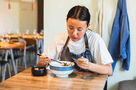 Korean Employee Taking a Break and Eating Soup in Restaurant