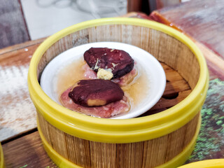 Chinese Steamed dumplings, shiitake mushroom with pork in small basket Delicious Dimsum pork.