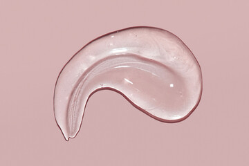 Cosmetic serum gel beauty swatch smear smudge on pink color background