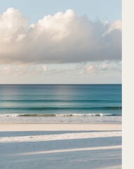 A beach with a blue ocean and a cloudy sky.