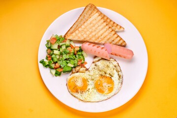 Breakfast Plate with Eggs, Vegetables, and Sausages