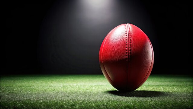 Aussie rules football with red leading lines on black background
