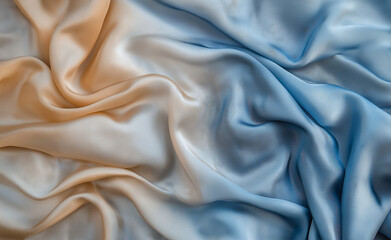 Obraz premium Close-up of flowing, luxurious silk fabric with soft golden and blue hues.