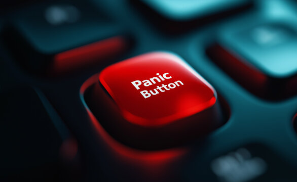 A glowing red panic button on a dark keyboard, symbolizing emergency or urgency.