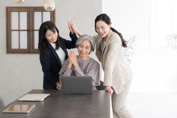Multiple businessmen working in teams of women of all ages High-fives for everyone happy with...