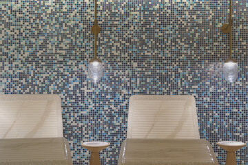 Thermal suite with heated loungers in mosaic tile design or relaxation chairs in spa or wellness...