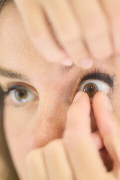 woman taking out her contact lens