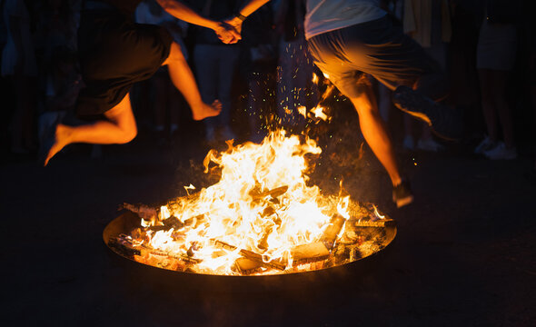 People jumping over fire